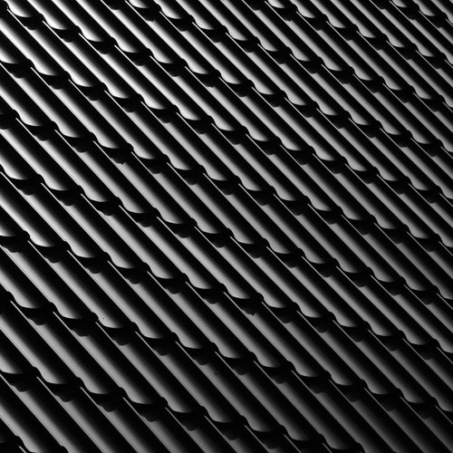 Abstract monochrome image featuring a sleek black tile roof with distinct patterns and shadows.